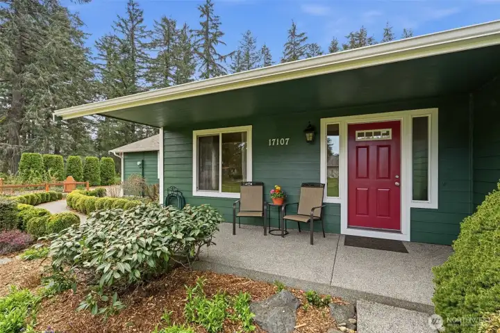 Covered Patio at the front door with paved walkaway from driveway