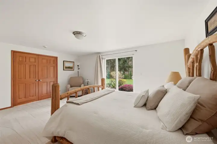 Big French Doors open to the Primary Bedroom with Sliding Glass door out to Patio & Backyard