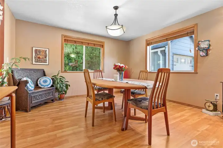 This spacious, light-filled dining room offers an inviting atmosphere perfect for both casual daily meals and elegant entertaining.