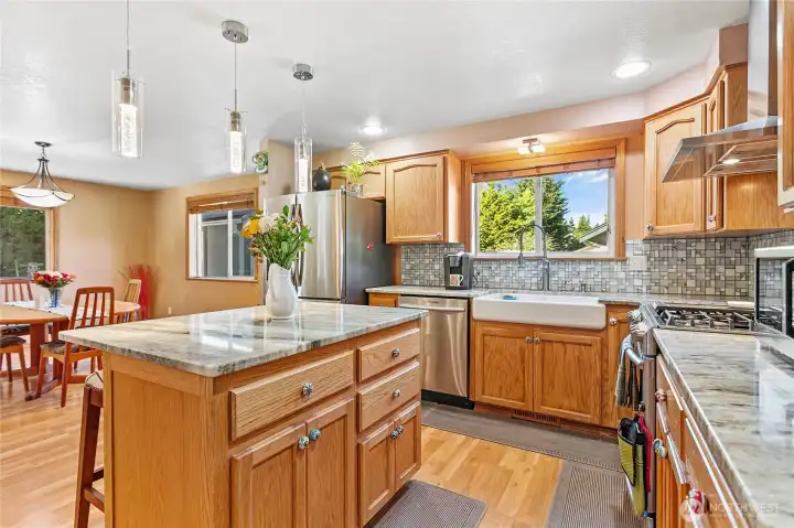 Spacious kitchen featuring an expansive island and generous counterspace, perfect for multiple cooks and effortless meal preparation.