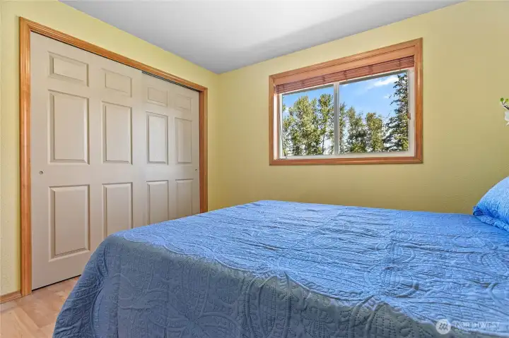 Spacious secondary bedroom featuring a large closet with shelving and ample natural light. This versatile space is perfect for a guest suite, home office, or hobby room.