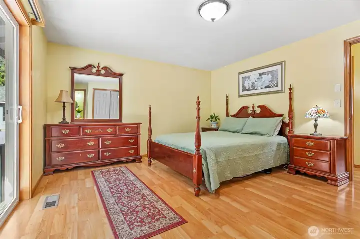 The primary bedroom is exceptionally spacious and offers ample room for a king-sized bed and additional furniture.