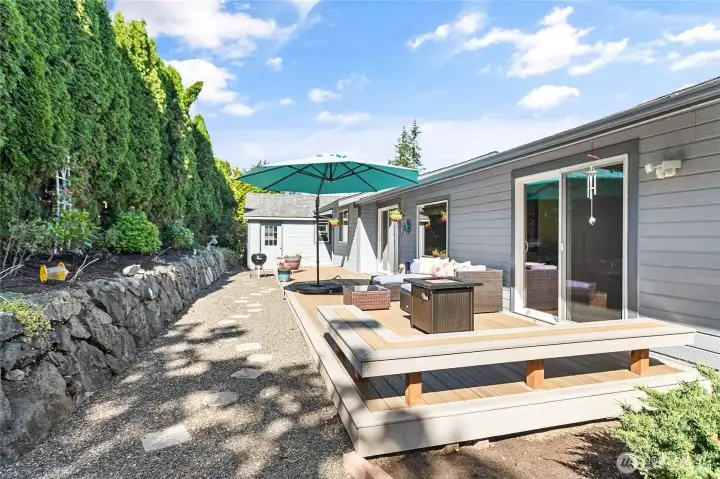The backyard features an expansive, mature garden that provides lush greenery and privacy.