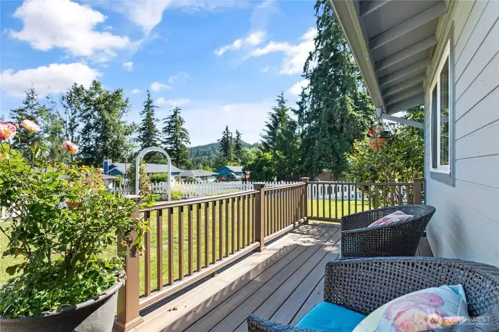 Gorgeous front deck with garden views, an ideal spot for enjoying your morning coffee.