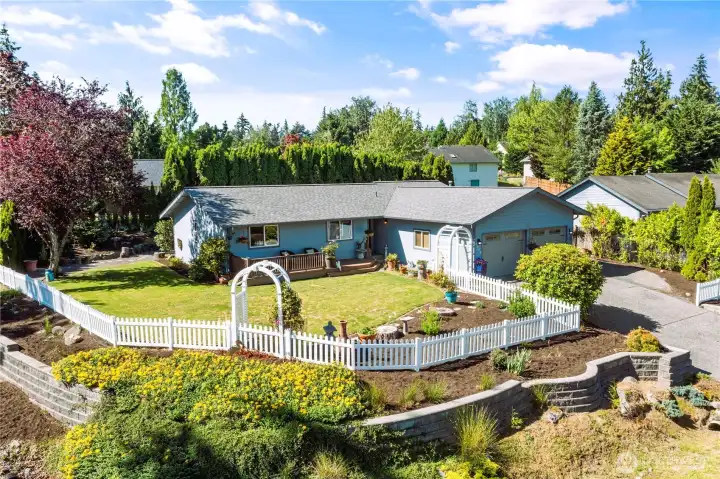 Welcome to your dream home, complete with a charming white picket fence.