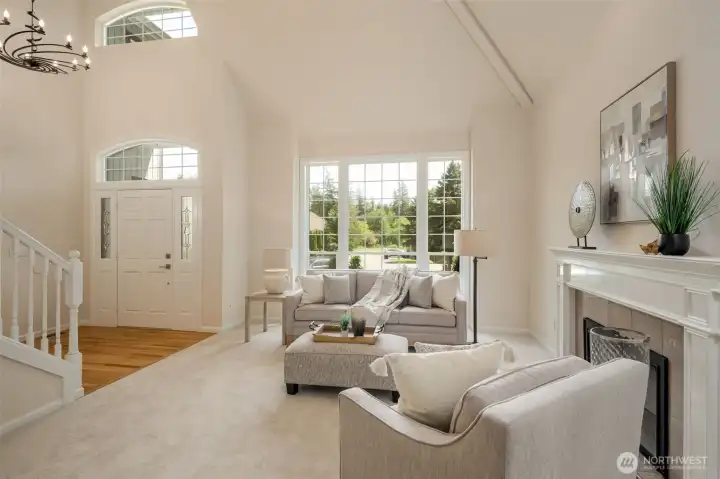 View from the living room to the dramatic entry featuring a designer entry light fixture!