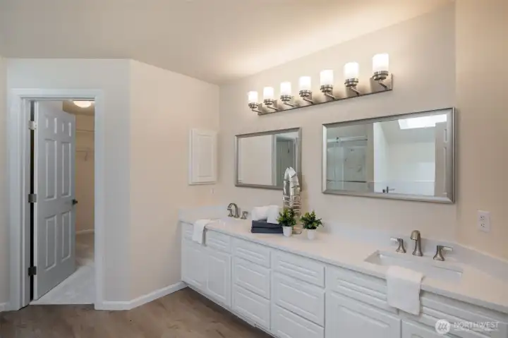 Completely remodeled primary bathroom with dual vanity, oversized shower and separate soaking tub.