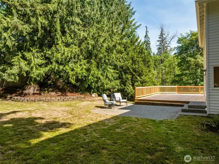 Tranquil backyard with patio and deck area.