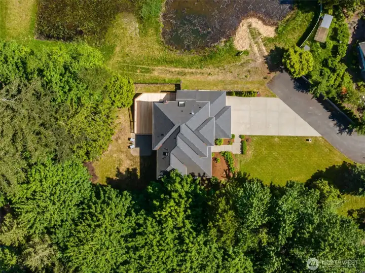 View from above showing the home and adjacent pond...if you love nature, you'll love living here!