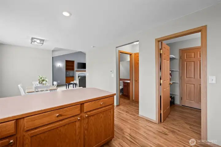 Dining room that flows seamlessly into the kitchen with stainless steel appliances.
