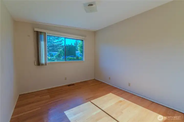2nd bedroom with oak floors. There are 3 bedrooms on upper level.