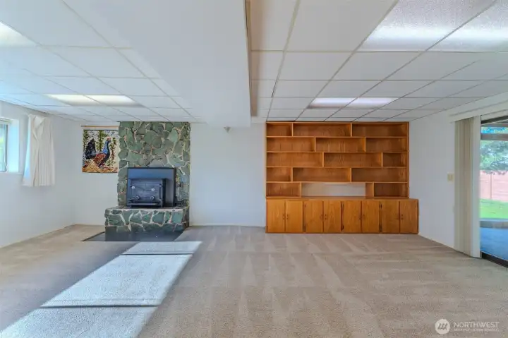 Huge open family room with a wall of windows and sliding door to enclosed patio.