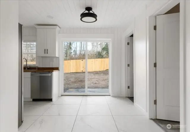 Nice and light dining area overlooking fenced rear yard.