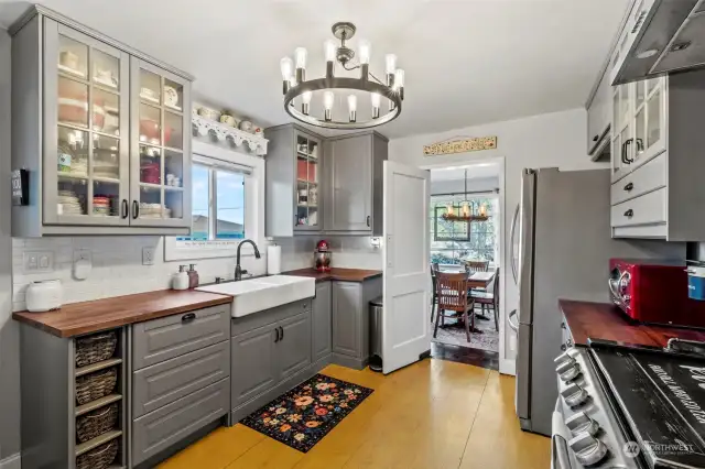 A sideway view of kitchen, showcasing excess storage and double farmhouse sink.