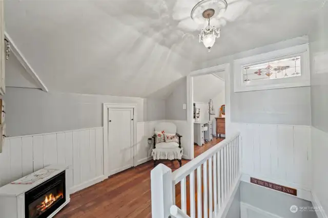 Upstairs hallway, cascaded with hardwood floors and vertical shiplap.