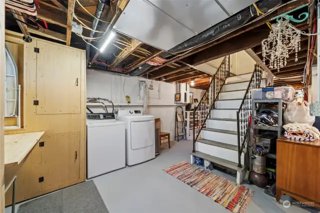 laundry space in basement, with excess storage and a double cast iron laundry sink.