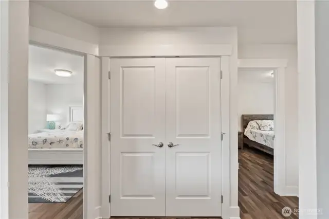 Laundry closet in  hallway between bedrooms