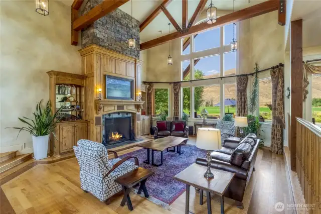 Main gathering room highlighted by 4 inch wide Oak flooring, high ceilings, picturesque windows, and a gas fireplace