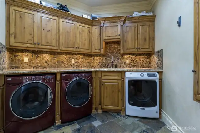 2 large washers and 1 dryer with counter space