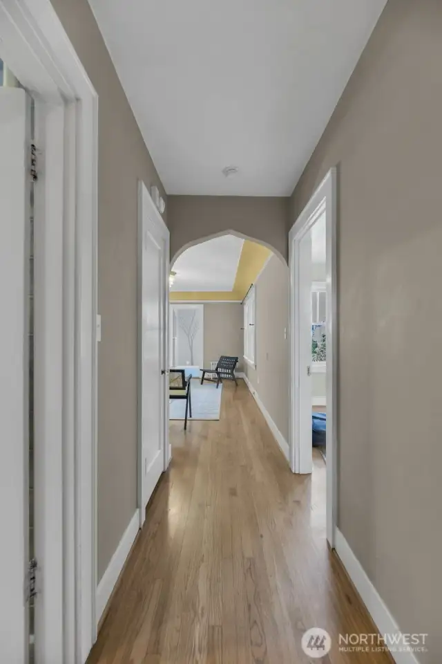 Entry way w/ storage. Bathroom on left. Bedroom on right. Living and kitchen through archway.
