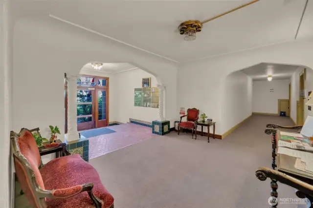 Lobby w/ mailboxes and community announcements. Stairwell to laundry on east side of building