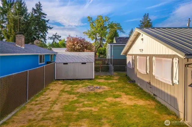 Fully fenced in yard with special dog house.