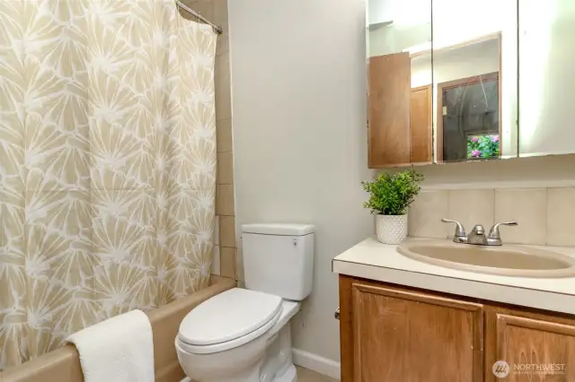 Full Bathroom located in hallway by 3 bedrooms.
