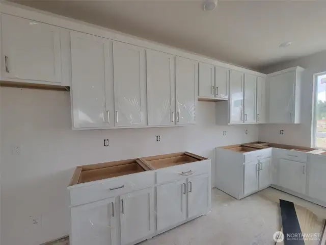 White cabinets being installed