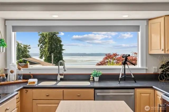 Imagine doing dishes with this incredible view—keep an eye out for whales!
