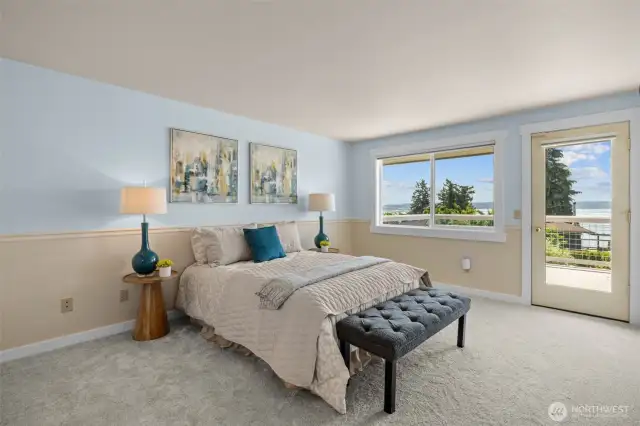 The primary suite captures stunning views and features direct deck access—perfect for morning coffee or dining al fresco.