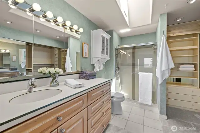 Light-filled roomy primary ensuite with a skylight, expansive layout, huge closet, and incredible storage space.