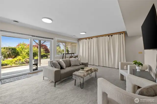 Massive bonus room featuring extensive built-in shelves and included TV—perfect for family fun or media nights.