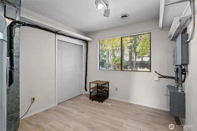 Versatile systems room with ample space and a closet, perfect for an office or creative workspace