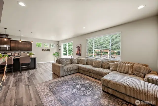 open concept living downstairs with two oversized, massive sliding doors