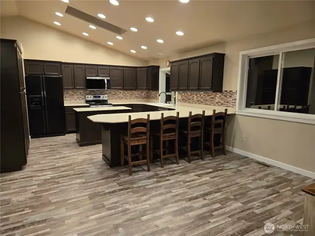 Spacious kitchen area with lots of cabinets.