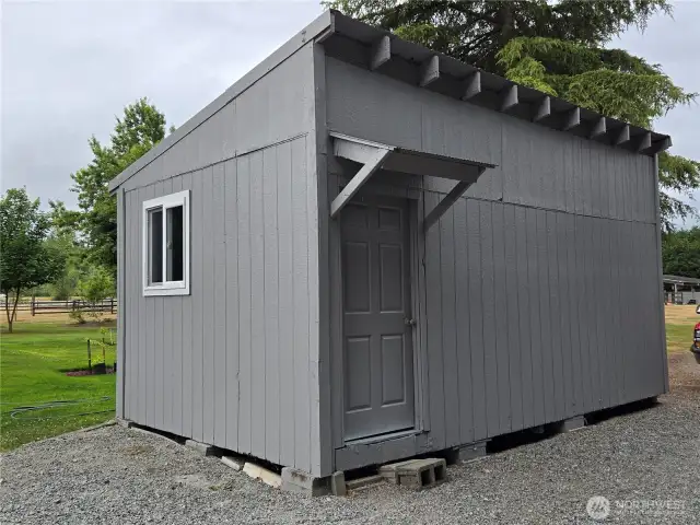 12 x 20 outbuilding with power, built in cabinets and shelves.