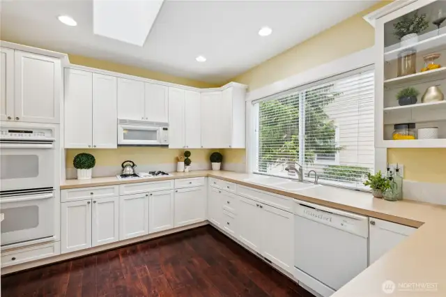 Spacious kitchen equipped with a double oven and natural gas range top perfect for cooking and entertaining with ease.