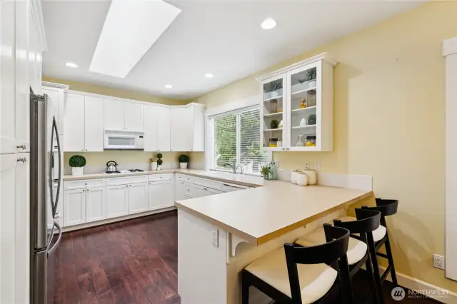 The kitchen includes a convenient eat-in bar, perfect for casual dining or entertaining guests.