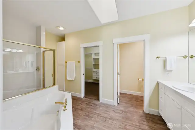 The spa-inspired primary bath includes a soaking tub, oversized shower, double sinks, and a private water closet designed for comfort and privacy.
