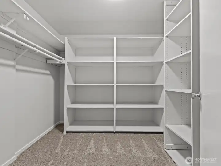The highly functional walk-in closet has more than enough space for the most extensive wardrobe.