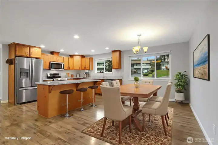 Dining Room and eat at island in the Kitchen with stainless steal appliances. *Virtually Staged*