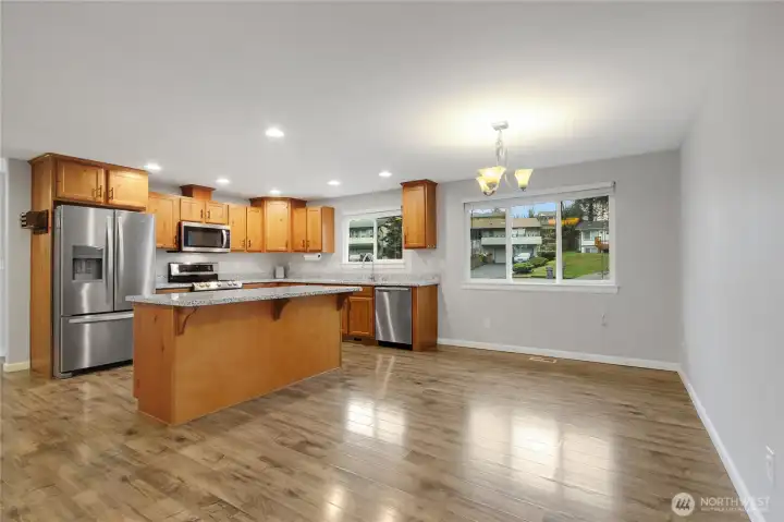 Dining Room and eat at island in the Kitchen with stainless steal appliances.