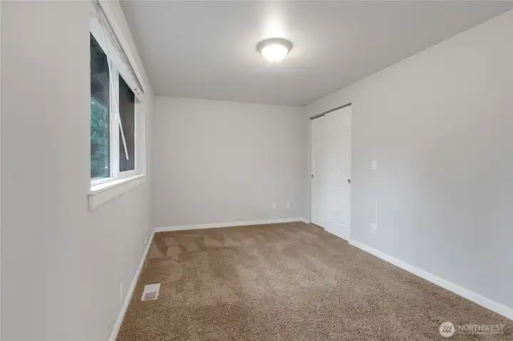 Primary Bedroom with a window facing the backyard.