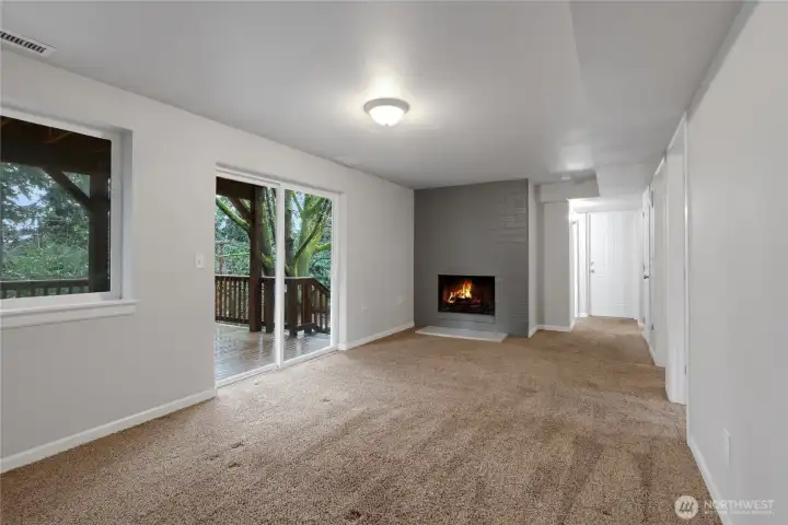 Downstairs Living Room with fire place and sliding door to backyard and lower deck.