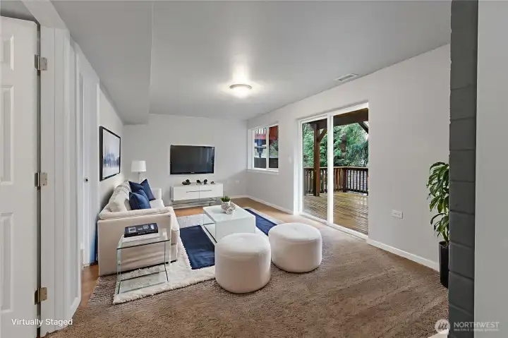 Downstairs Living Room with sliding door to lower deck and backyard. *Virtually Staged*