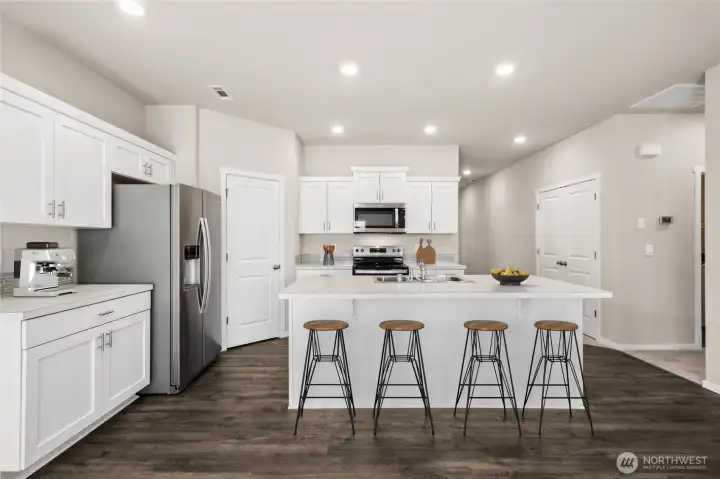 Virtually staged. Laminate flooring through main living spaces of the home. Photos are for representational purposes only. Colors and finishes may vary.