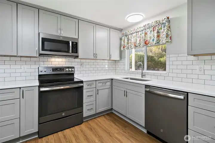 Gorgeous cabinetry and stainless appliances.