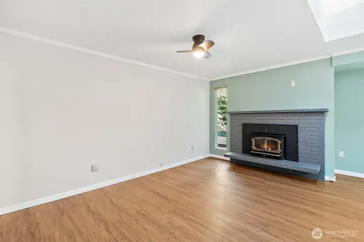 Living room with wood burning fireplace.