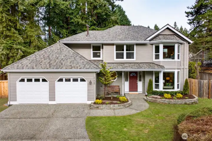 A classic English Hill two story with a welcoming approach, mature evergreens, and tidy landscaping that frames the home beautifully. The new roof and two car garage add peace of mind and everyday practicality right from the start.