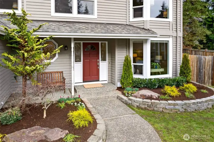 The covered entry feels inviting and practical, with an easy path from driveway to front door. Mature plantings soften the edges and add privacy. This is the kind of arrival that feels calm and intentional.